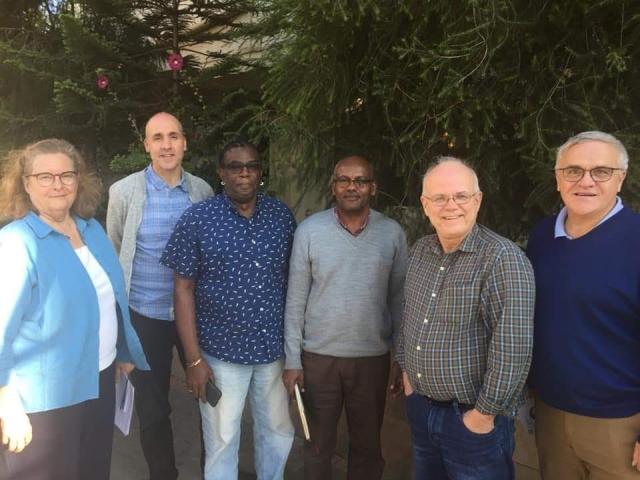 Six members of the CFGB Board of Directors in a line smiling at the camera in Ethiopia