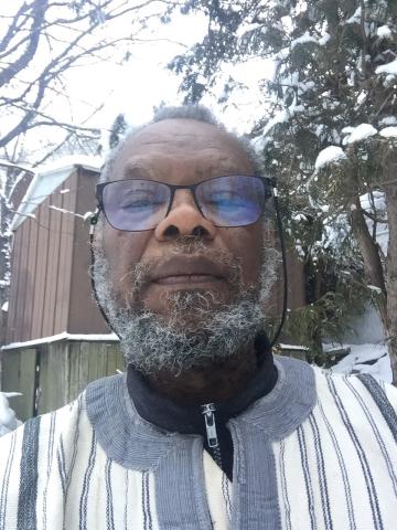 A selfie of Rev. Dr. Samuel Vauvert Dansokho, a Black man with a graying beard and glasses. Photographed outside in a snowy background.