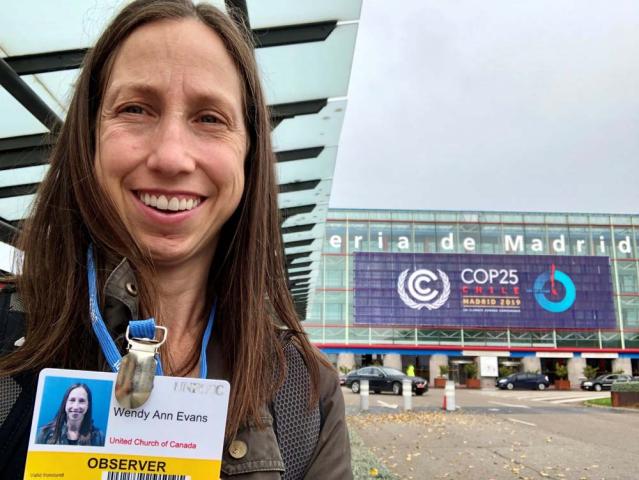 Wendy Evans displays her ID badge from the COP 25 Climate Summit.