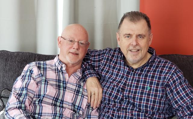 Harry Stewart and Chris Southin, founders of Rainbow Camp, seated on sofa