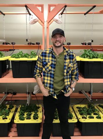 Jesse stands in the ydroponic greenhouse at Stella’s Circle. 