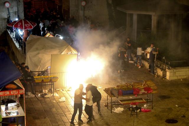People run from an explosion at nighttime near the Damascus Gate, Jerusalem