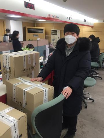 Boxes packed with personel protection equipment sit on a table, ready to be sent by PROK to neighbouing countries