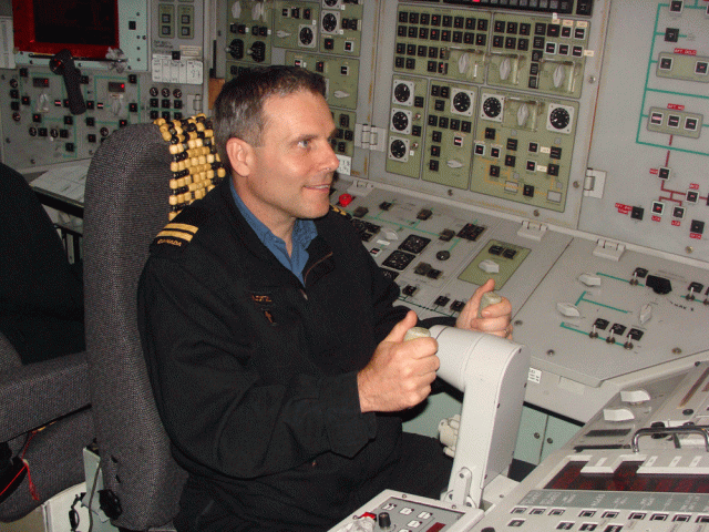 Padre Klotz at the helm of a submarine.