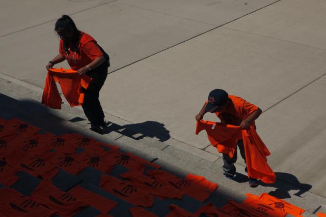 orange shirts displayed on steps outside legislature building