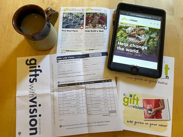 Photo of Gift catalogue, tablet with website, order sheet and a coffee mug