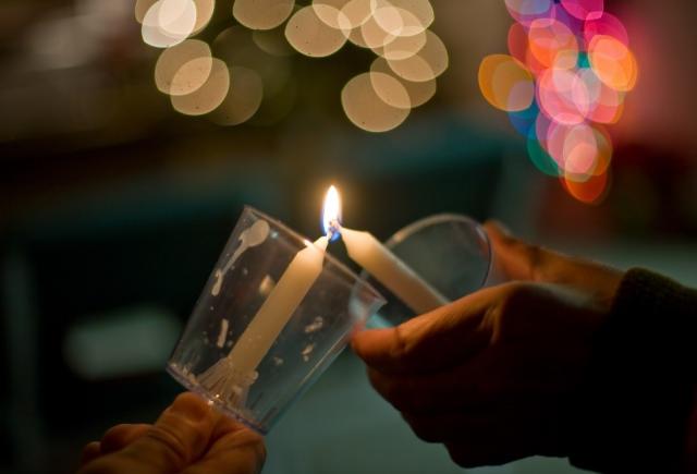 A candle being lit from another candle