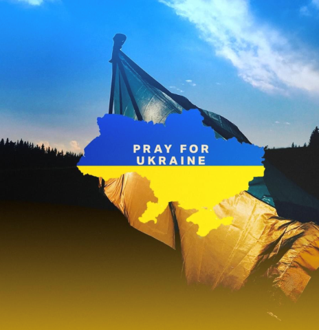 A map of Ukraine with the words Pray for Ukraine in white across it, against a background of the Ukrainian flag.