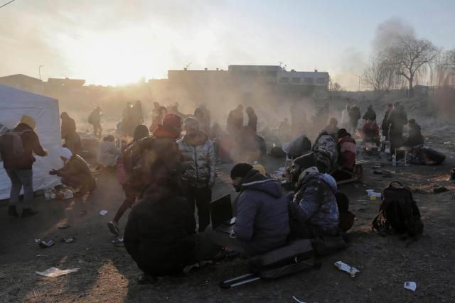 Refugees try to stay warm at the Medyka border crossing in Poland after fleeing the Russian invasion of Ukraine.