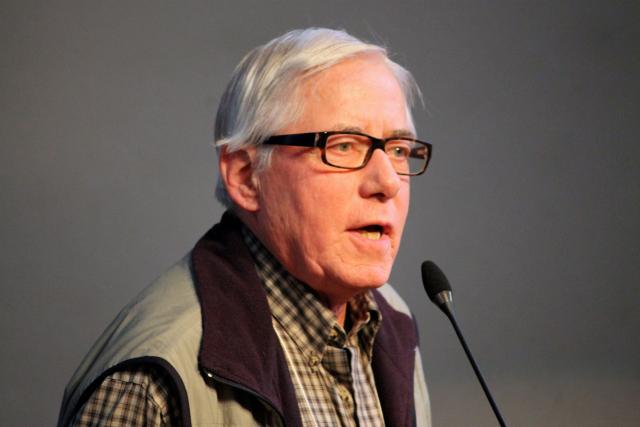 Photo of Bill Phipps speaking at a microphone