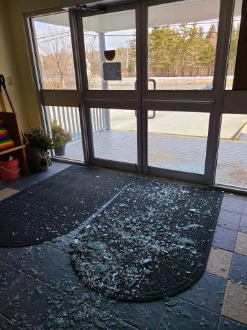 Shattered glass is scattered on the floor of St. Luke's church entrance from the shattered glass front door.
