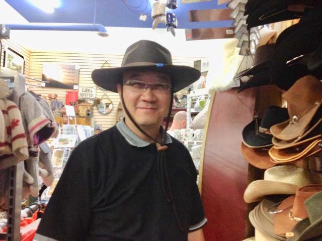 Calin Chun-hong Lau tries on a Canadian Mountie Hat in a souvenir shop.