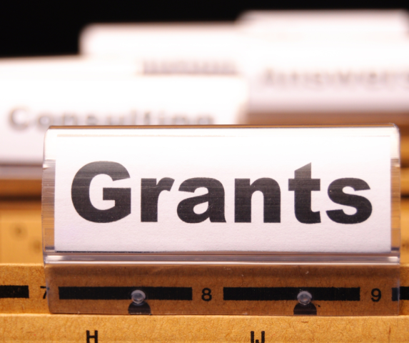 Closeup on the word Grants printed on the tab of a file folder