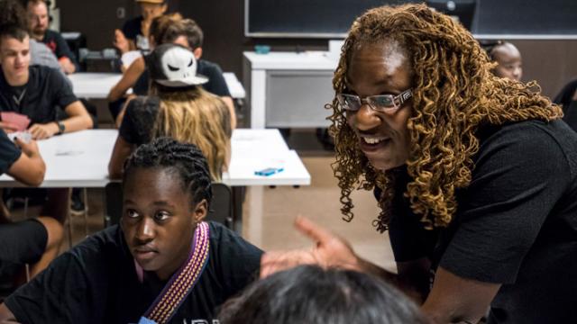 Adele Halliday talks to young adults sitting around tables at Rendez-vous 2017.