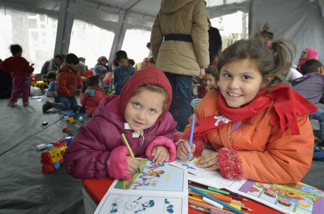 Two young refugees from Afghanistan play in a Serbian refugee centre.