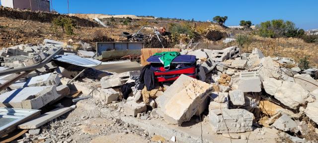 A pile of concrete rubble and smashed home belongings of the Abu S. family home after destruction.