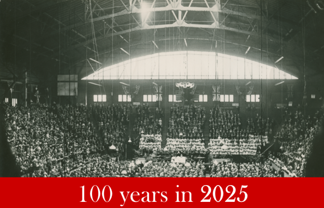 People fill an arena in a black and white photo from 1925. The words "100 years in 2025" are on a red background below.