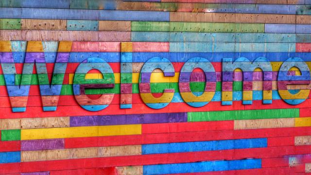 A multicoloured wooden sign spells out welcome