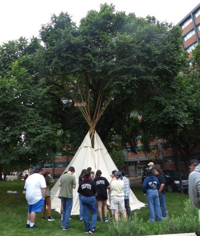 Youth participants at NISG 2023 raise a teepee