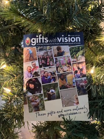 The 2023 Gifts with Vision catalogue hangs on a Christmas tree