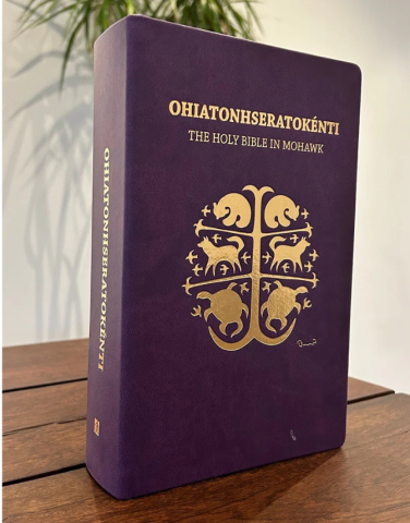 The Mohawk Bible has a purple cover with Indigenous art stamped in gold