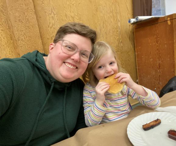 The author, Tori Mullin, with their daughter at a Shrove Tuesday dinner.