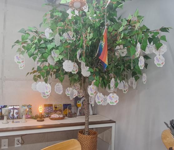 A small indoor tree with notes hanging from the branches