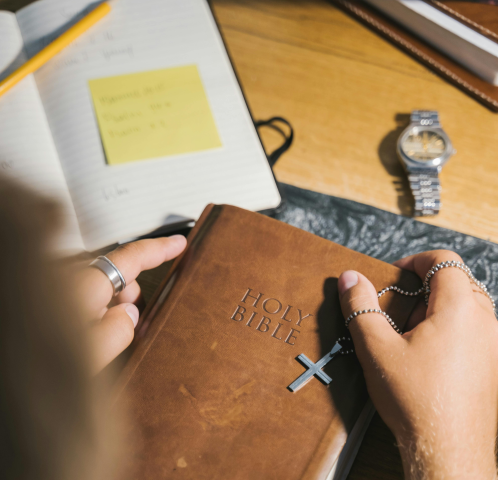 A person's hands holding a Bible.