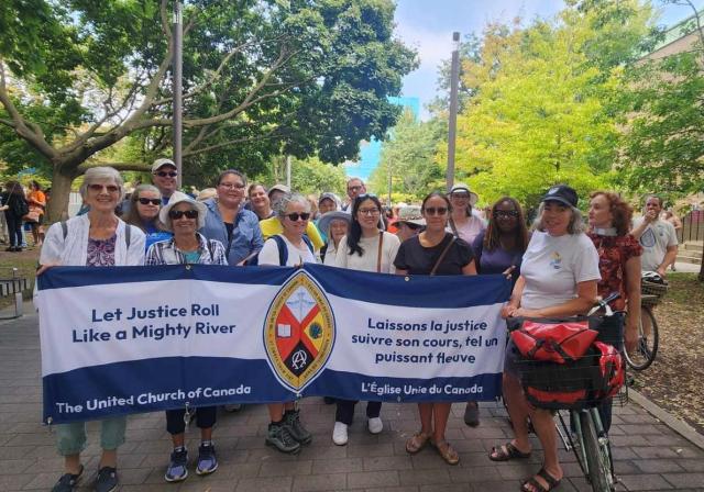 Members of the United Church hold a banner at the Grassy Narrows march in Toronto