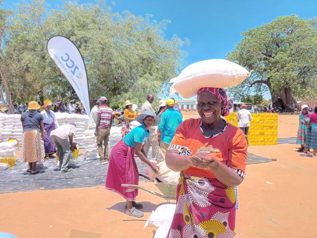 A woman receives food assistance in Zimbabwe