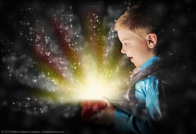 A boy smiles as he opens a gift