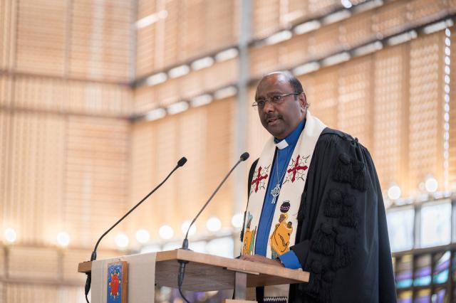 A photo of Rev. Prof. Dr. Jerry Pillay speaking at a lectern.