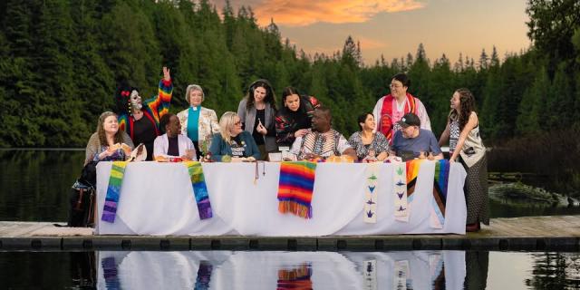 "A Place at the Table" - an iconic image of 12 diverse disciples at a long table, positioned on a dock in a mountain lake.