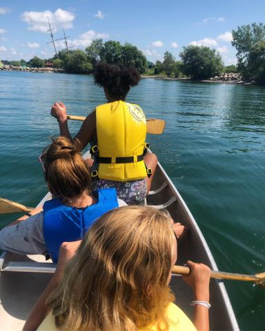 Children at Cave Springs Camp paddle a canoe