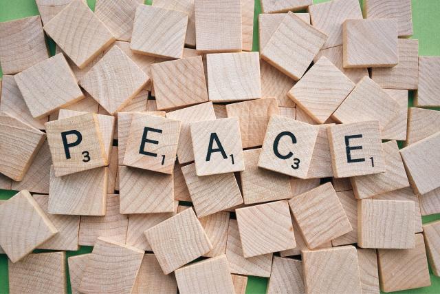 Scrabble letter tiles spelling out "Peace"