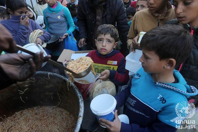 Children gather to receive food from a charity in Gaza
