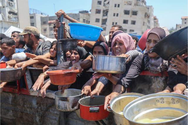 Palestinians gather for food aid