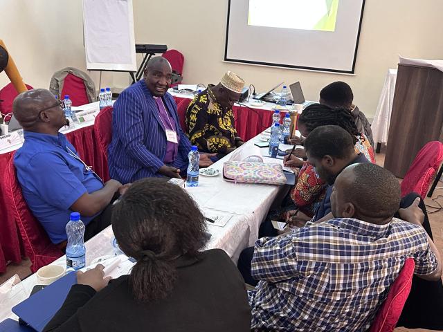 A small group having a discussion at a table in a conference room
