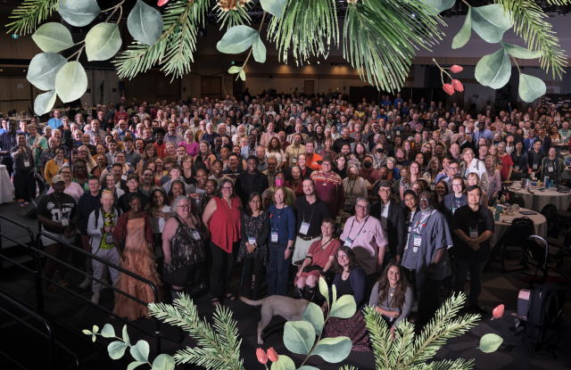A large group photo with a Christmas wreath overlaid