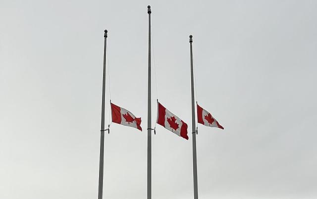 Three Canadian flags at half-mast