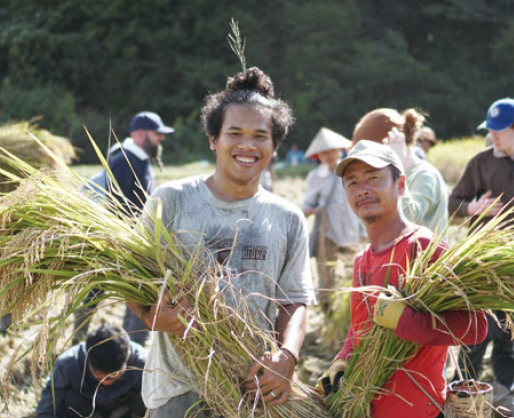 Participants with Asian Rural Institute harvest crops