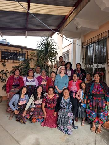 A group of smiling women outdoors in colourful clothing