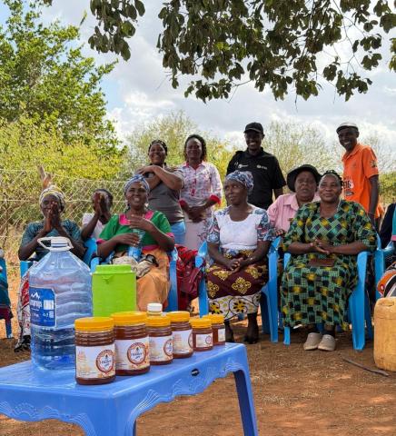 A group of African women and men smiling and laughing 