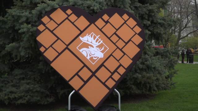 A large sign in the shape of a heart with a white moose icon in the middle