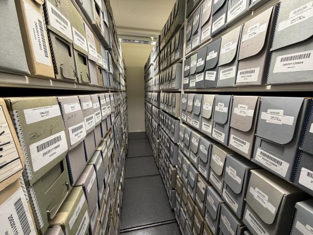 Rows of labelled archival boxes