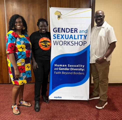 Three smiling adults stand near a poster that says "Faith Beyond Borders" and "Gender and Sexuality Workshop"