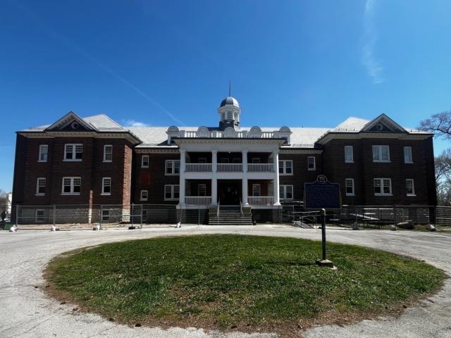 A large brick building with a circular driveway