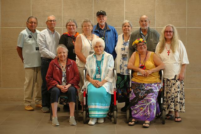 A group of 11 elders pose in line