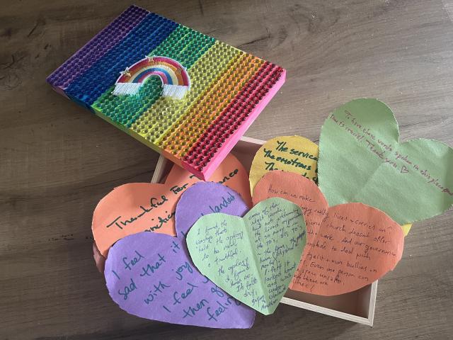 Rainbow hearts made of paper with writing on them