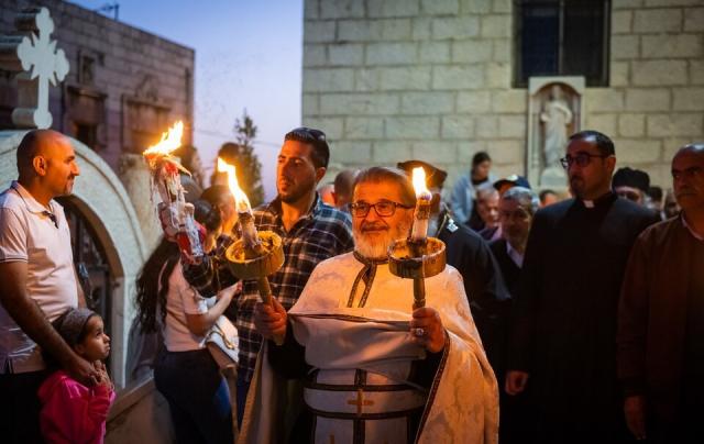 An easter procession outdoors attended by Palestinians